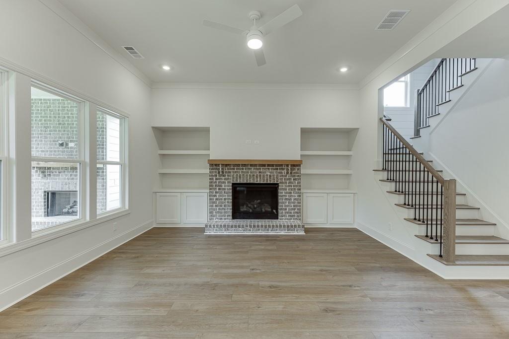 314 Level Creek Road Sugar Hill, GA 30518 - Photo 12 of 62 a view of an empty room with wooden floor fireplace and a window