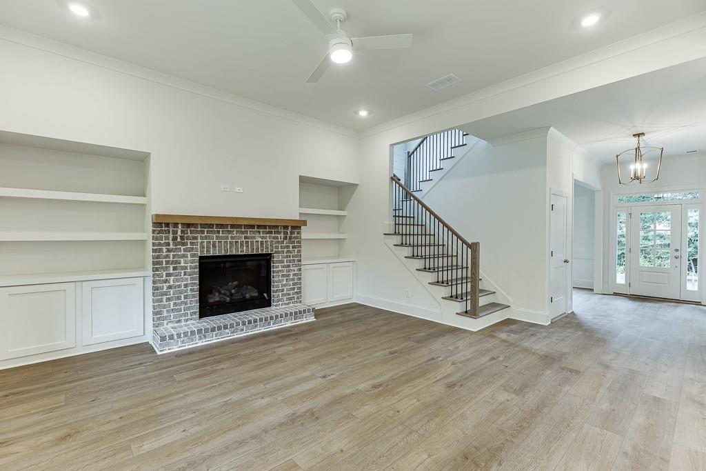 314 Level Creek Road Sugar Hill, GA 30518 - Photo 13 of 62 a view of an empty room with wooden floor fireplace and a window