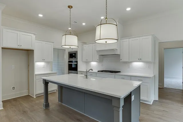 a kitchen with a sink chandelier and a fireplace