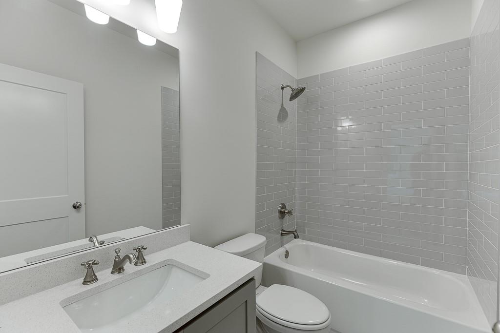 314 Level Creek Road Sugar Hill, GA 30518 - Photo 33 of 62 a bathroom with a sink a toilet and bathtub