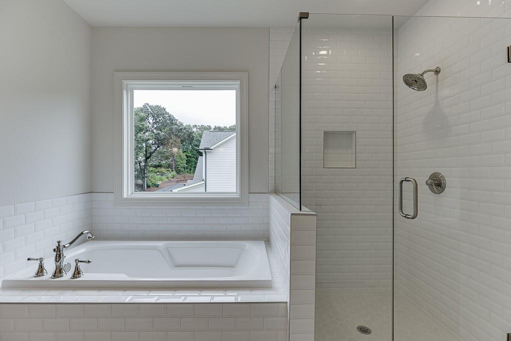 314 Level Creek Road Sugar Hill, GA 30518 - Photo 44 of 62 a bathroom with a bathtub and shower