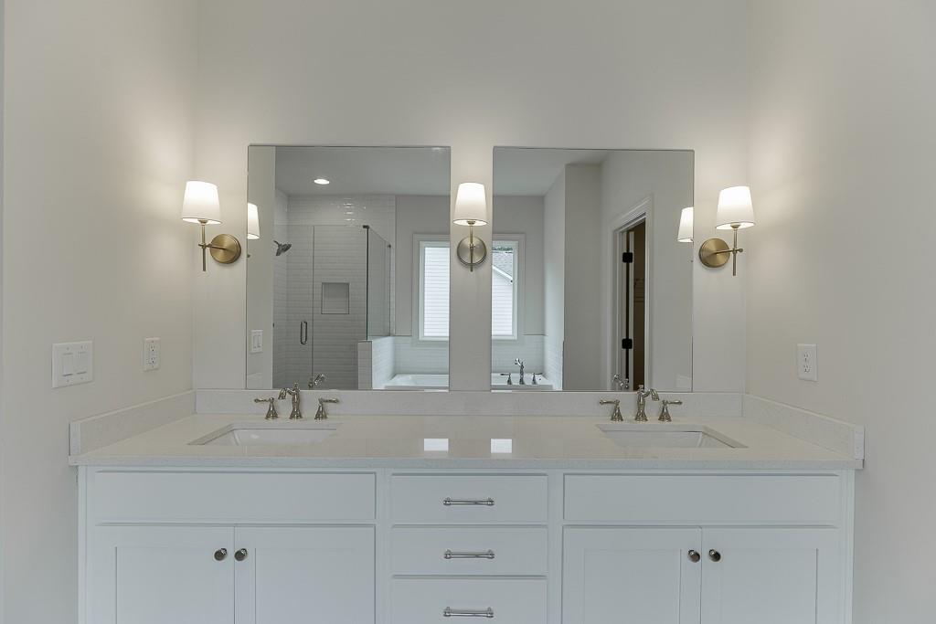 314 Level Creek Road Sugar Hill, GA 30518 - Photo 45 of 62 a bathroom with double vanity sinks and a mirror