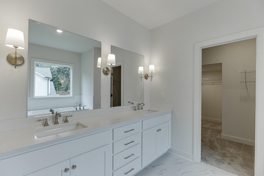 314 Level Creek Road Sugar Hill, GA 30518 - Photo 46 of 62 a bathroom with double sink and a mirror