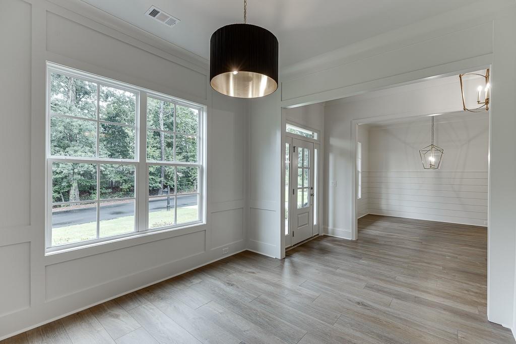 314 Level Creek Road Sugar Hill, GA 30518 - Photo 7 of 62 a view of an empty room with wooden floor and a window