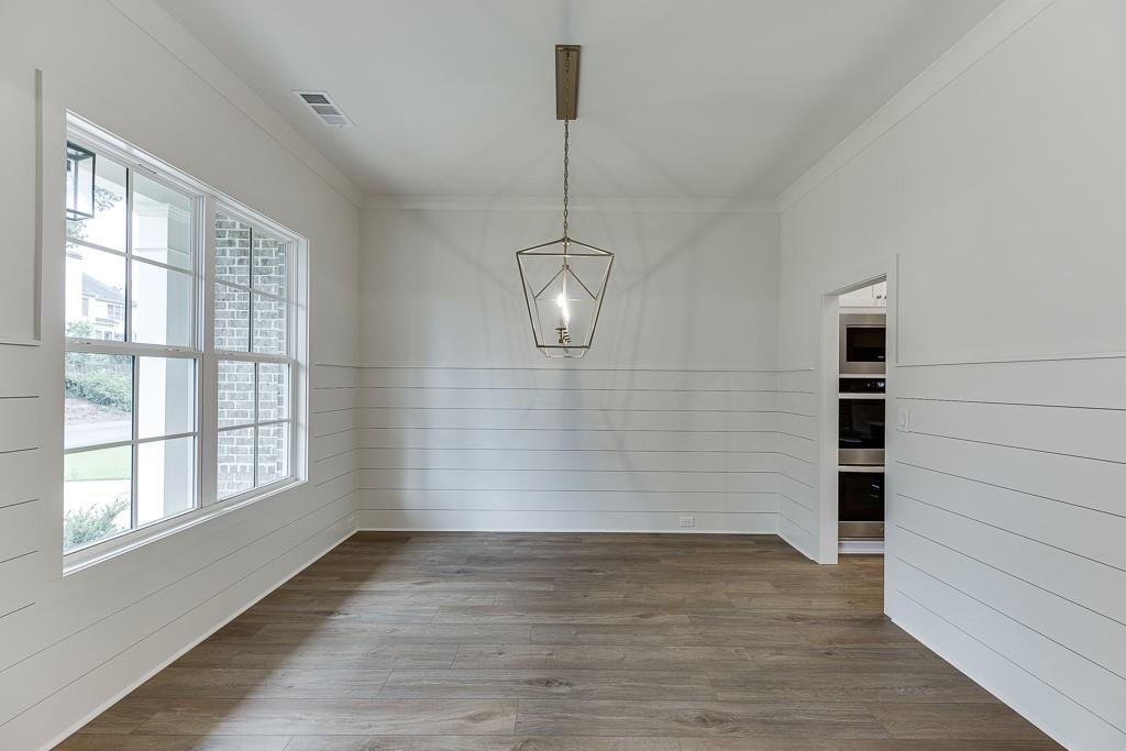 314 Level Creek Road Sugar Hill, GA 30518 - Photo 8 of 62 a view of empty room with wooden floor and windows
