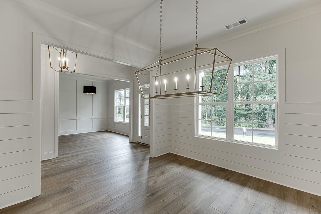 314 Level Creek Road Sugar Hill, GA 30518 - Photo 10 of 62 a view of a room with wooden floor fireplace and windows