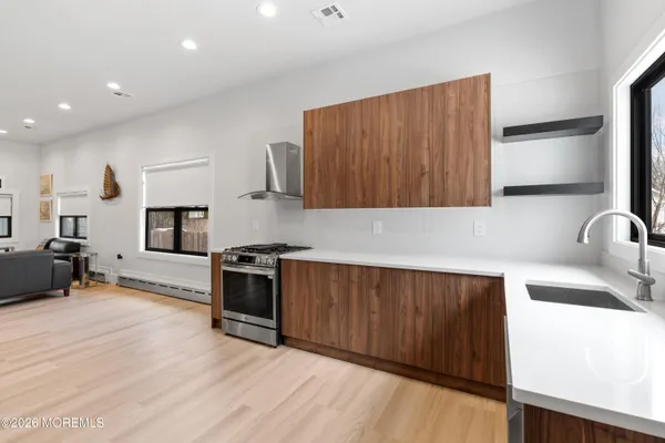 a kitchen with stainless steel appliances a refrigerator and wooden cabinets