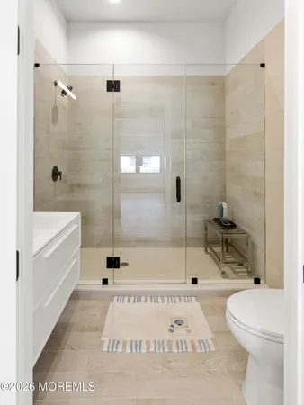a bathroom with a toilet and a shower