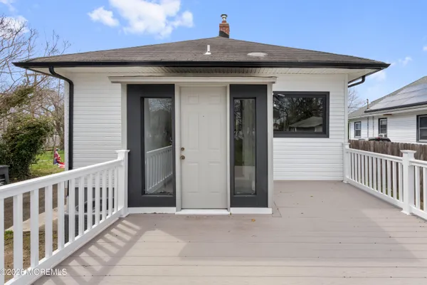 a view of a house with a wooden deck