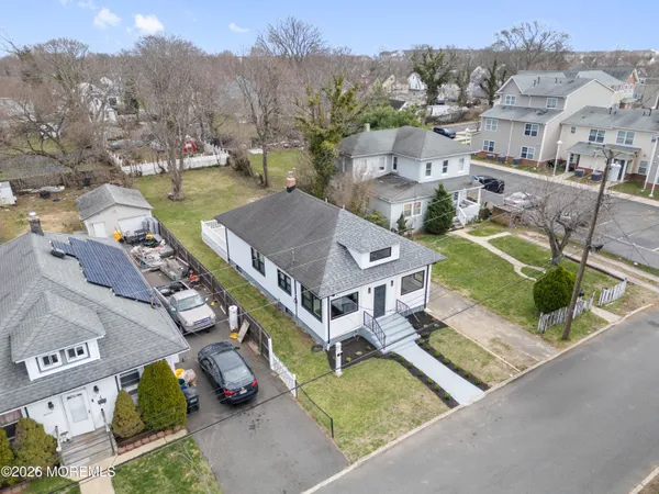 an aerial view of multiple houses with yard