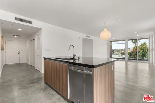 a kitchen with granite countertop a stove and a sink