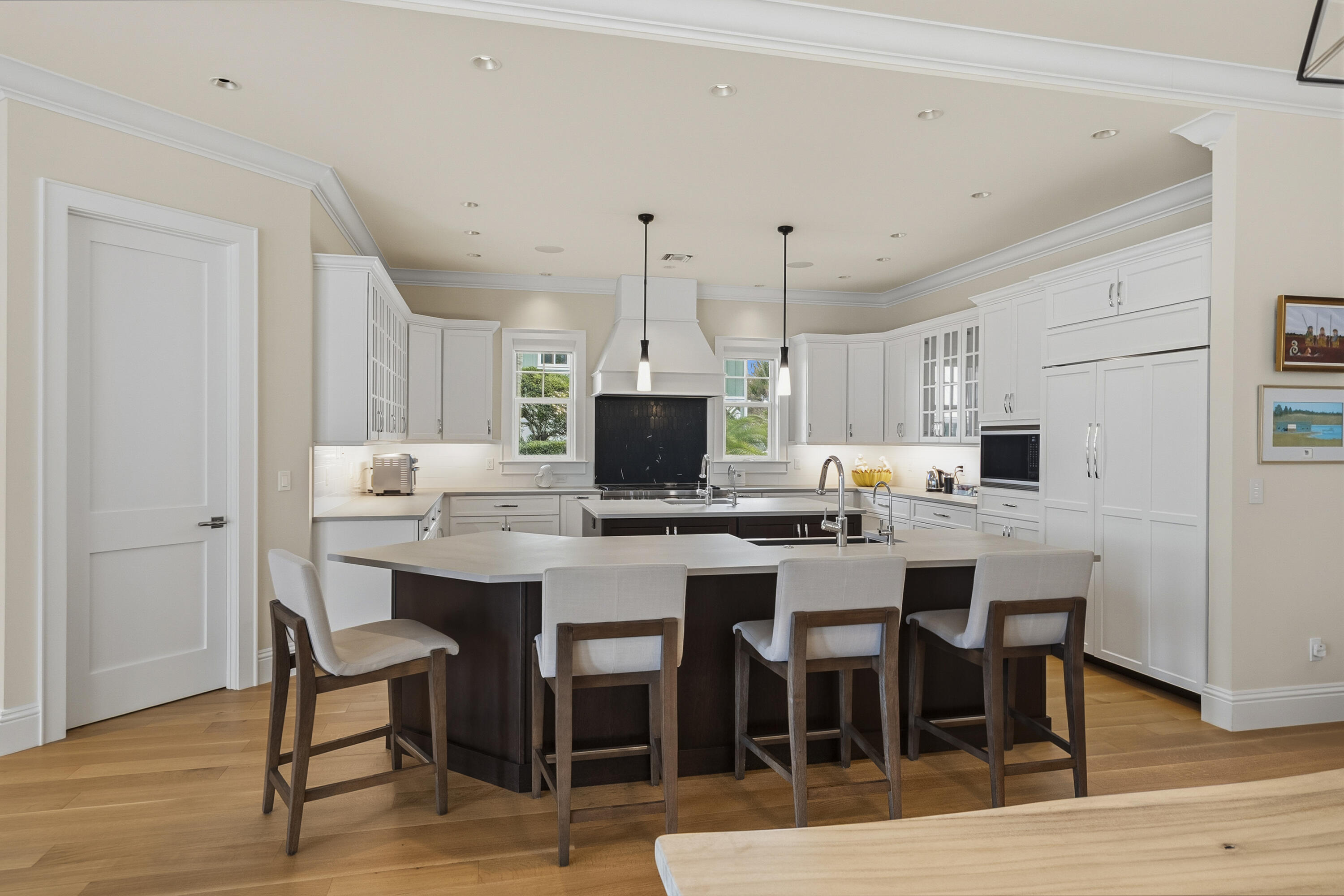 3973 Southeast Topsail Court Stuart, FL 34997 - Photo 8 of 38 a kitchen with a dining table chairs and wooden floor