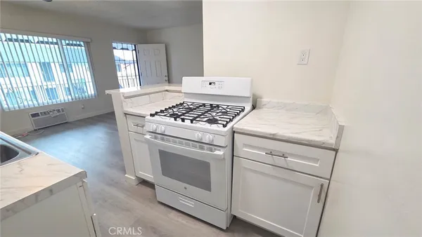 a kitchen with a sink stove and cabinets