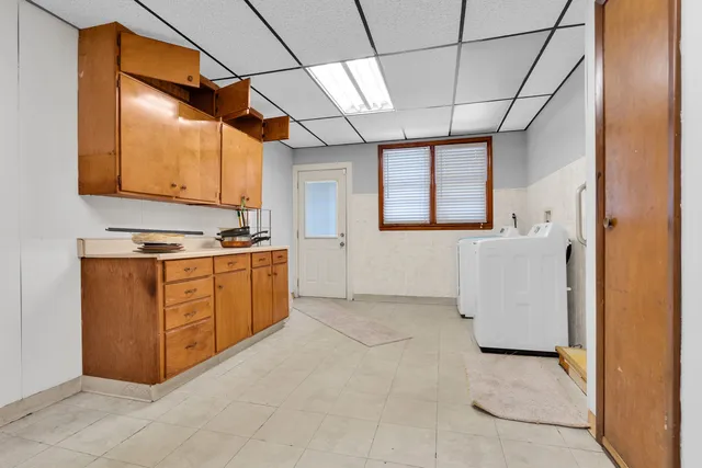 a kitchen with cabinets and window