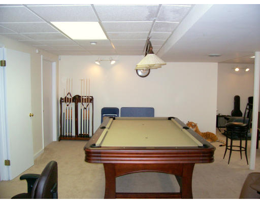 46 Azalea Road Sharon, MA 02067 - Photo 27 of 28 a room with furniture and a chandelier