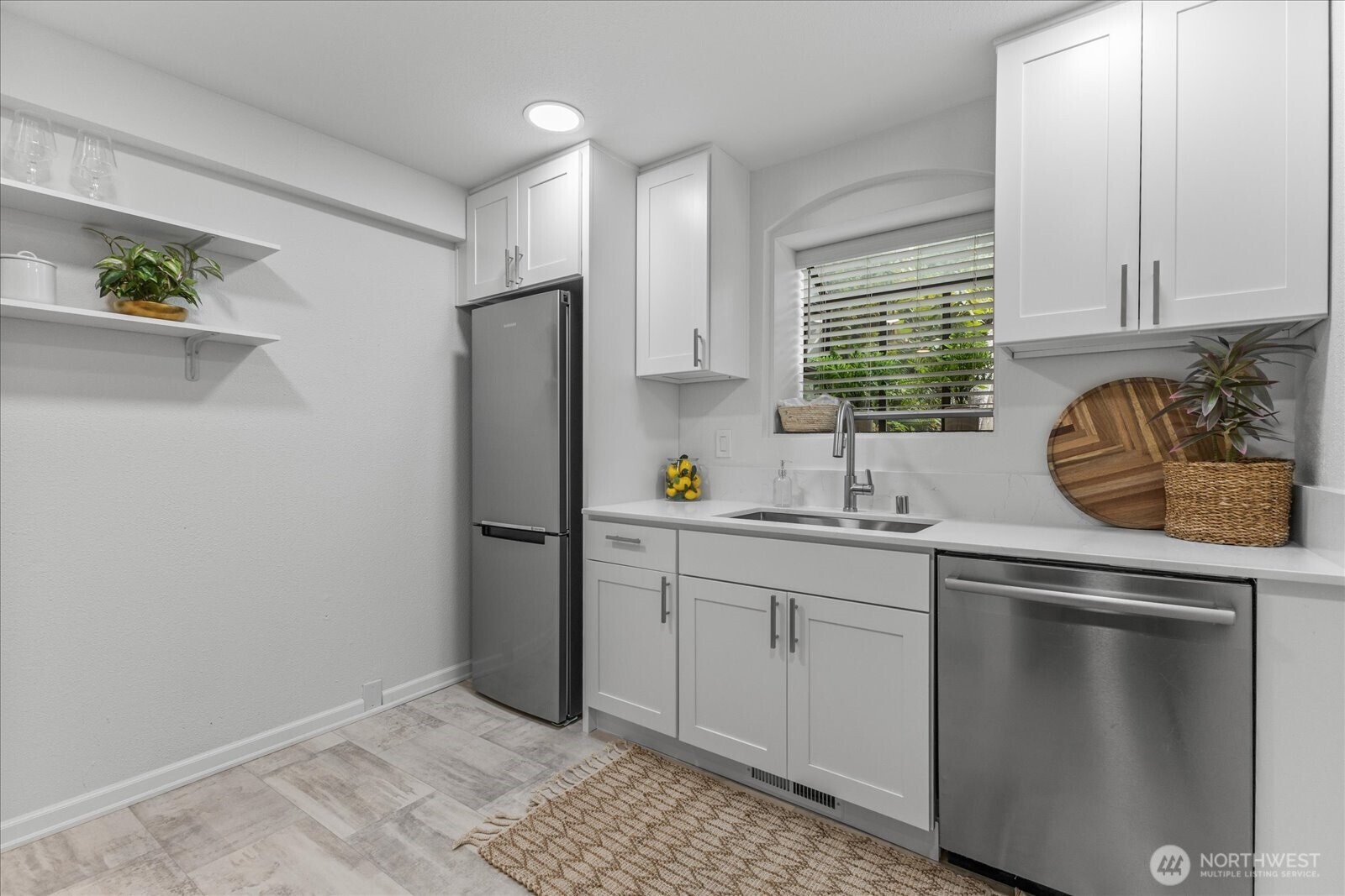3921 108th Avenue Northeast, Unit A101 Bellevue, WA 98004 - Photo 11 of 27 a kitchen with stainless steel appliances granite countertop a sink stove and refrigerator