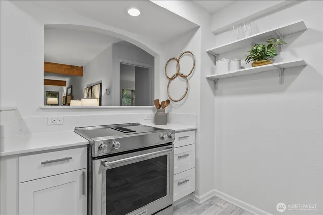 a kitchen with a stove and cabinets