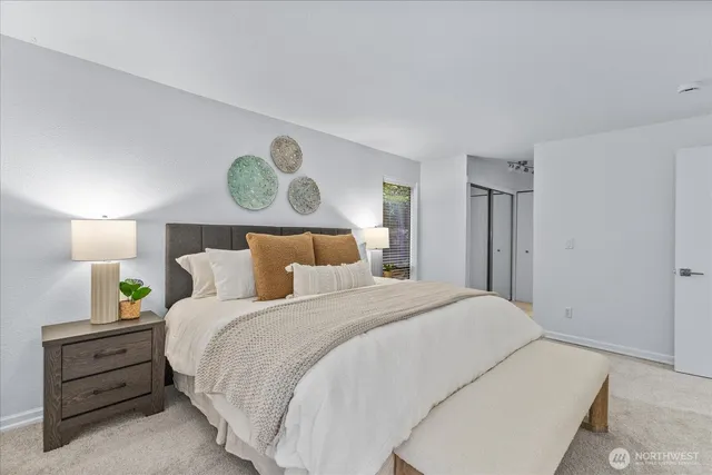 a bedroom with a bed and cabinets