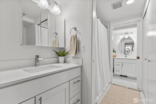 a bathroom with a sink and a mirror