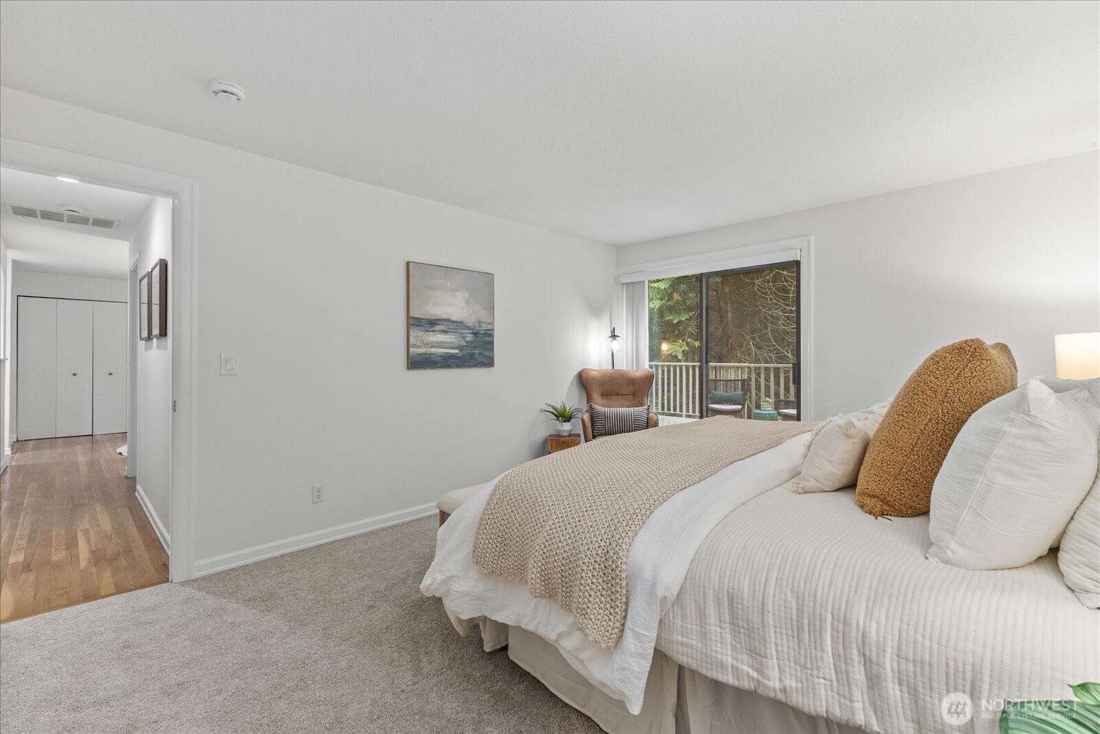 3921 108th Avenue Northeast, Unit A101 Bellevue, WA 98004 - Photo 19 of 27 a bedroom with a bed and a painting