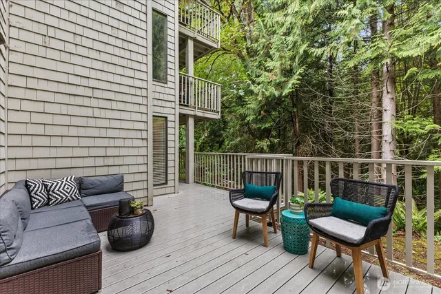 a balcony with wooden floor and furniture