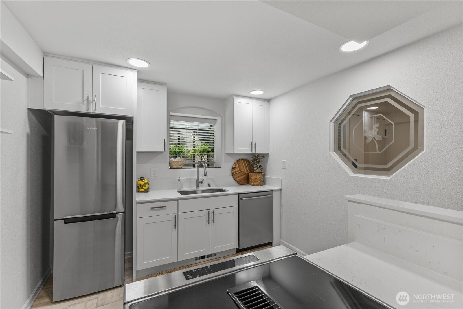 3921 108th Avenue Northeast, Unit A101 Bellevue, WA 98004 - Photo 10 of 27 a kitchen with stainless steel appliances a refrigerator sink and cabinets