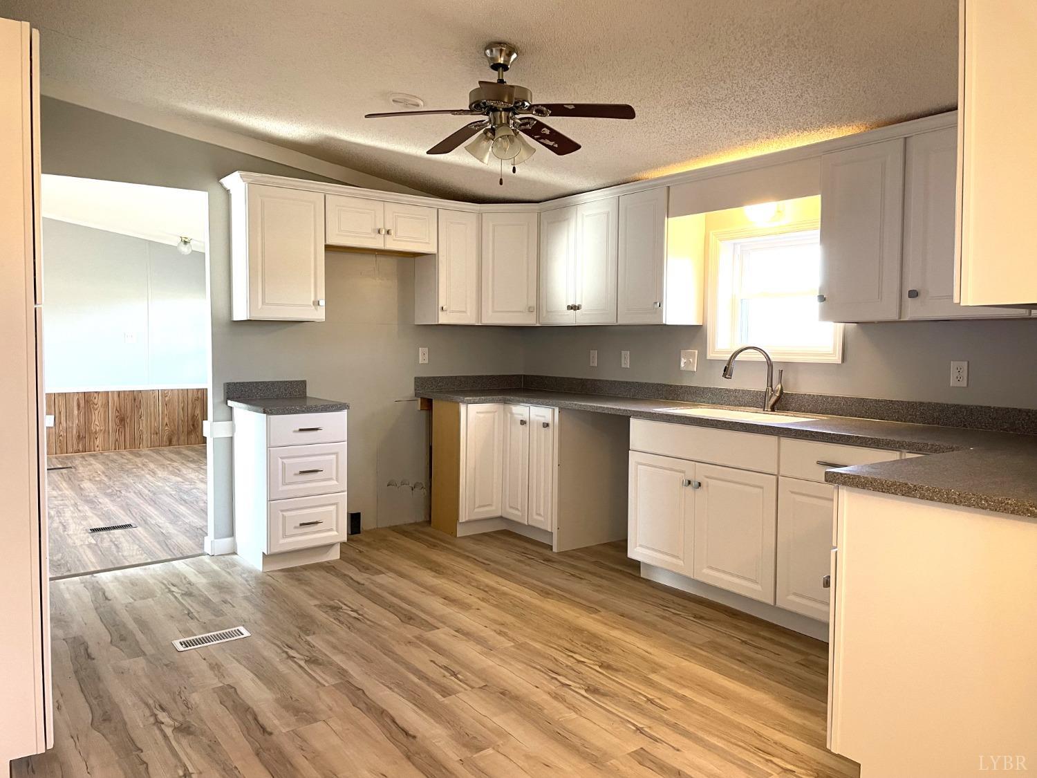232 Camp Branch Road Gretna, VA 24557 - Photo 11 of 47 a kitchen with a sink cabinets and window