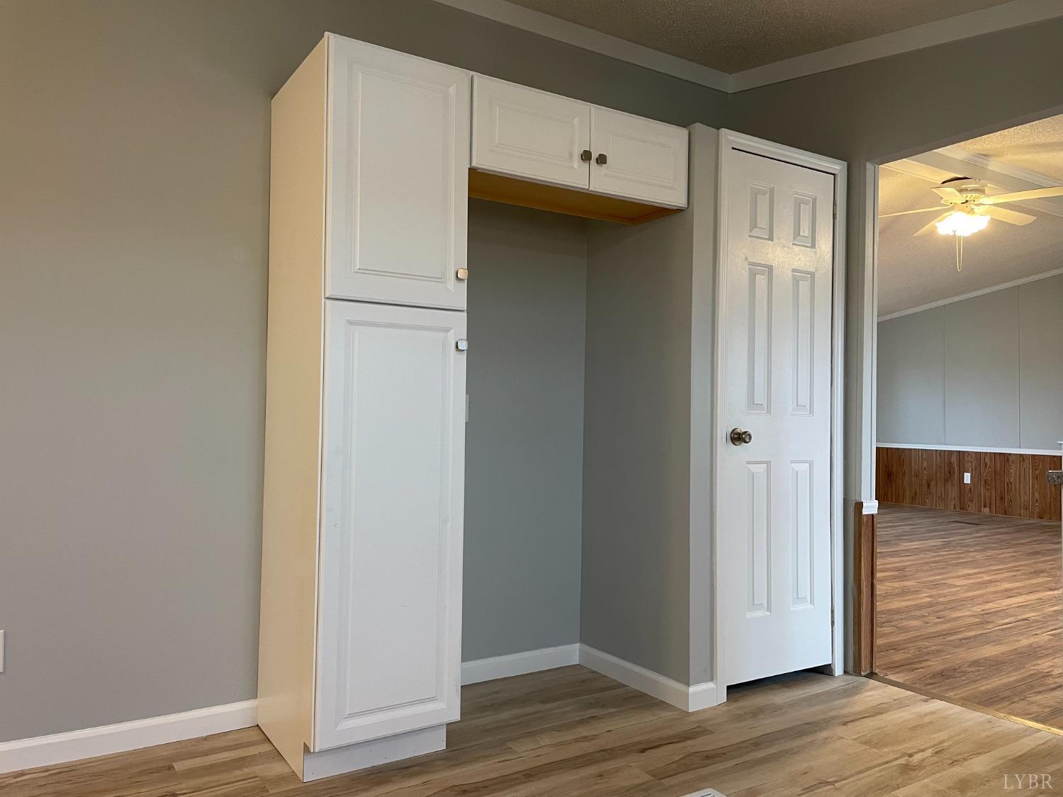 232 Camp Branch Road Gretna, VA 24557 - Photo 13 of 47 a view of a refrigerator in kitchen and wooden floor