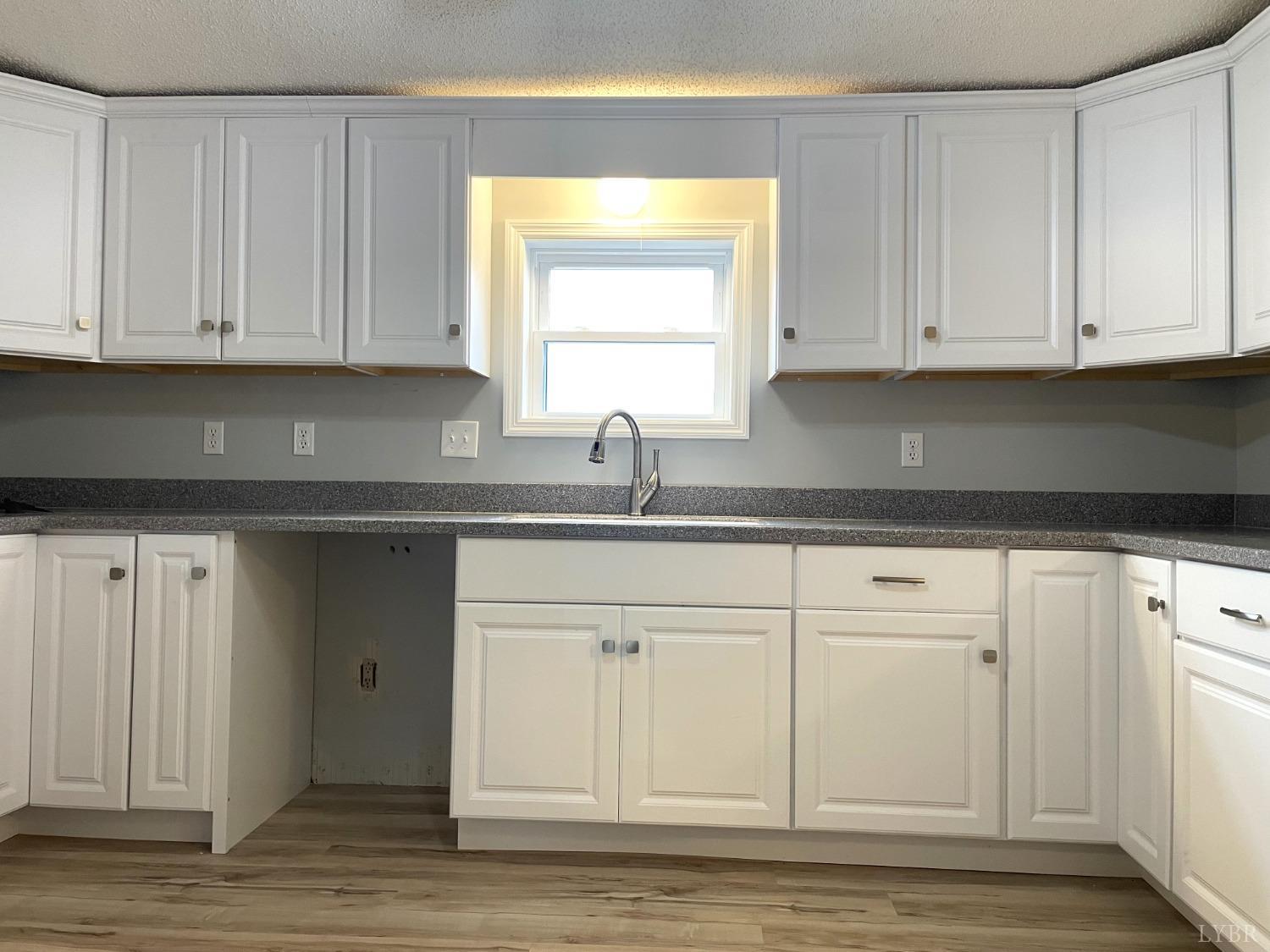232 Camp Branch Road Gretna, VA 24557 - Photo 15 of 47 a kitchen with granite countertop white cabinets and sink