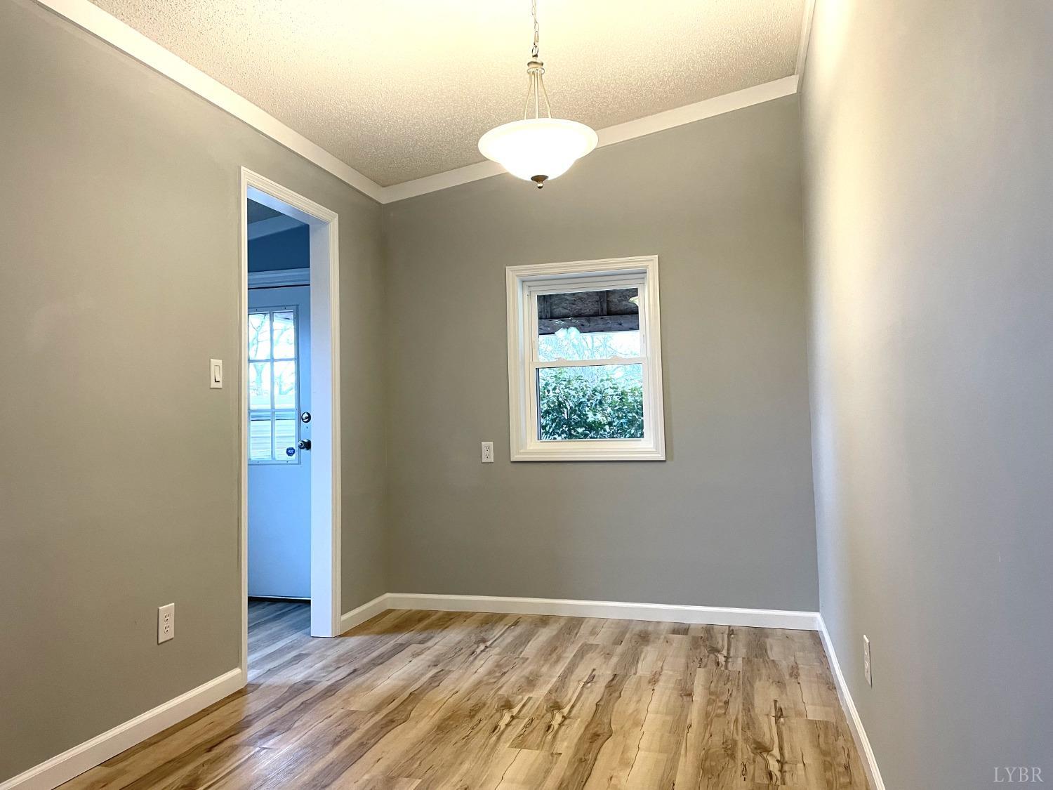 232 Camp Branch Road Gretna, VA 24557 - Photo 19 of 47 an empty room with wooden floor and windows