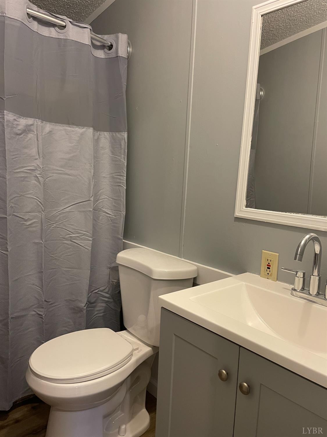 232 Camp Branch Road Gretna, VA 24557 - Photo 31 of 47 a white toilet sitting next to a bathroom sink