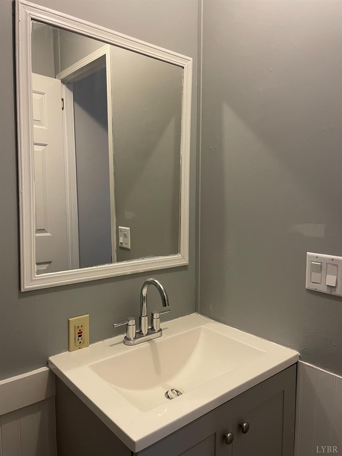 232 Camp Branch Road Gretna, VA 24557 - Photo 32 of 47 a bathroom with a sink vanity and a mirror