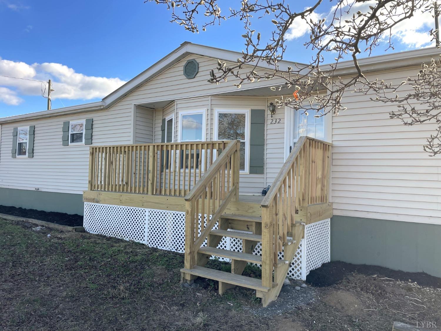 232 Camp Branch Road Gretna, VA 24557 - Photo 4 of 47 a view of a house with a yard and wooden fence