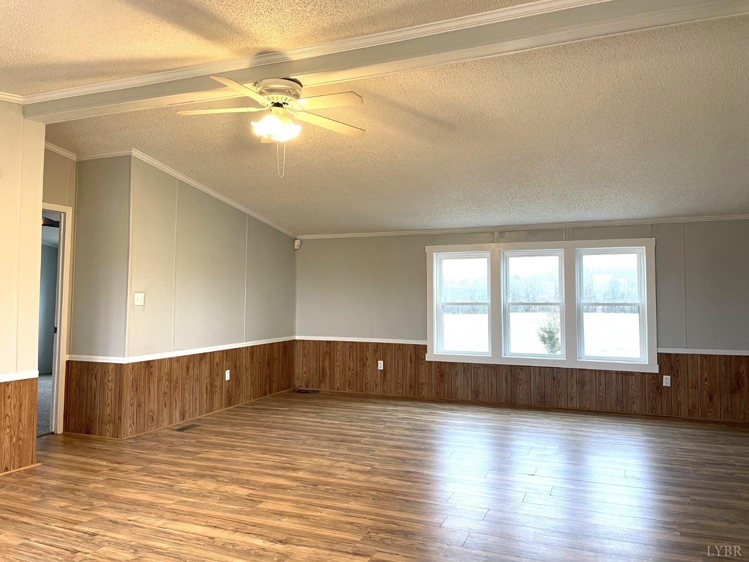 232 Camp Branch Road Gretna, VA 24557 - Photo 7 of 47 a view of an empty room with wooden floor and a window
