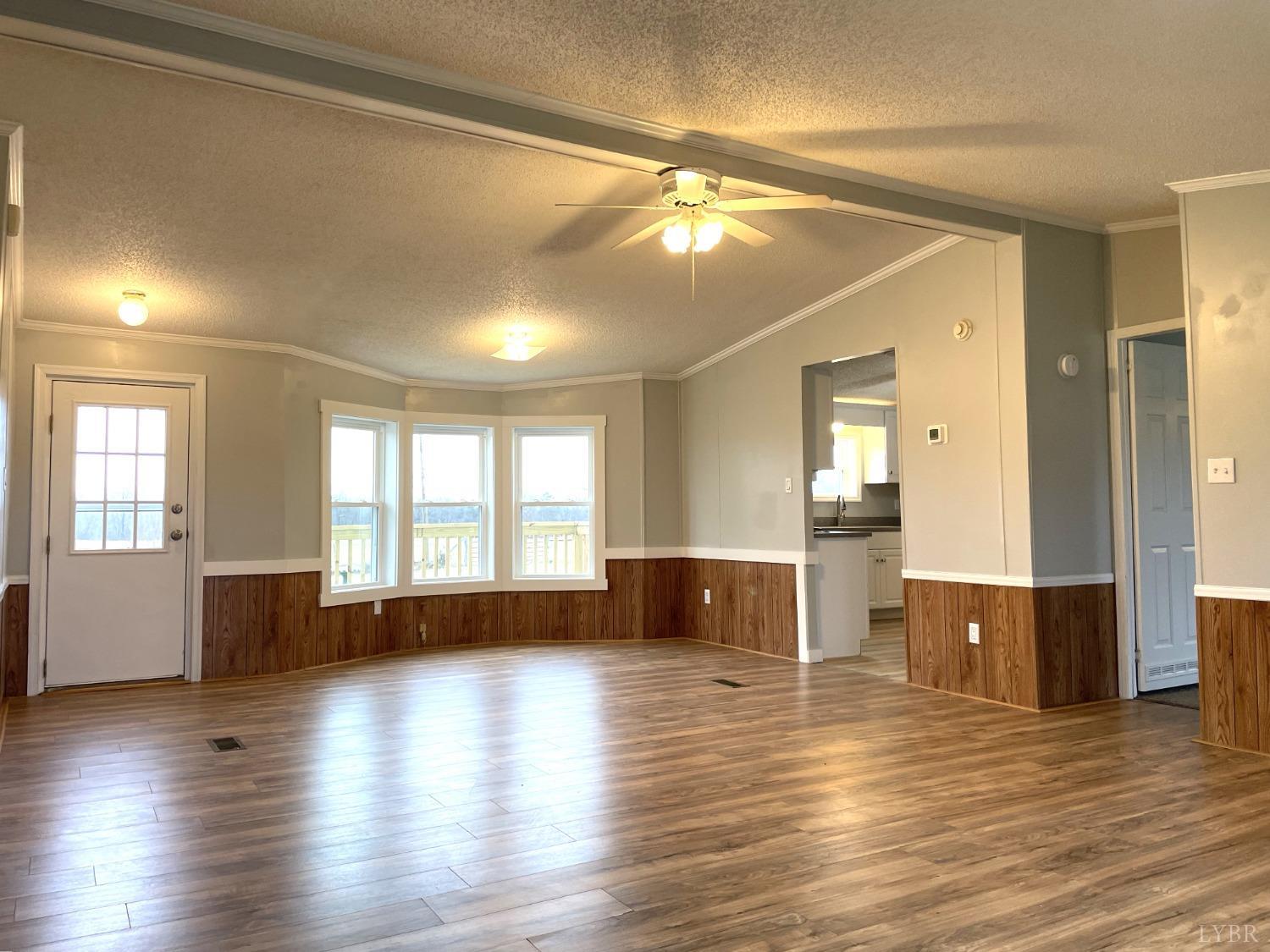 232 Camp Branch Road Gretna, VA 24557 - Photo 10 of 47 a view of empty room with wooden floor and fan