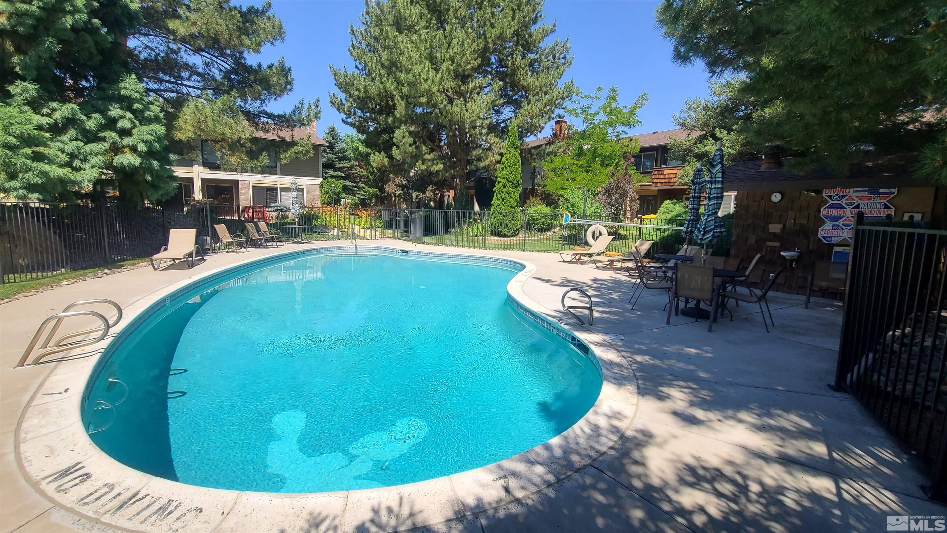 1407 Foster Drive Reno, NV 89509 - Photo 3 of 34 a view of a swimming pool with back yard of a house