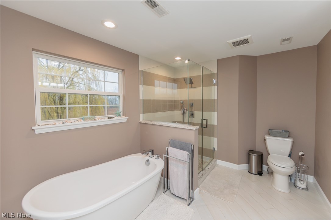 32883 Walnut Drive Avon, OH 44011 - Photo 18 of 34 Bathroom featuring shower with separate bathtub, tile flooring, and toilet