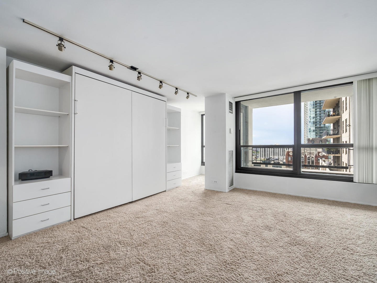 1030 North State Street, Unit 13A Chicago, IL 60610 - Photo 3 of 17 a view of an empty room with a window