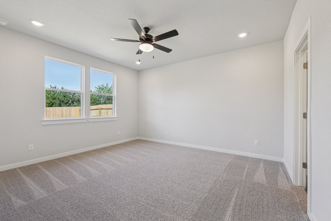 1216 Lavender Way Georgetown, TX 78628 - Photo 12 of 40 an empty room with windows and fan