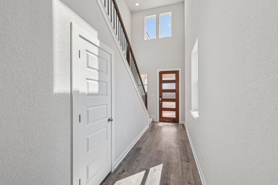 1216 Lavender Way Georgetown, TX 78628 - Photo 26 of 40 a view of a hallway with wooden floor and staircase