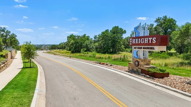 a sign board with a street sign on the side of the road