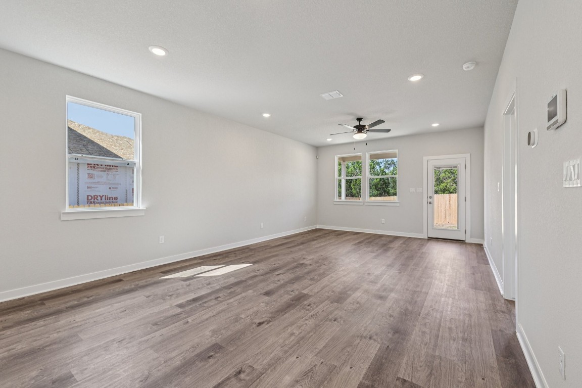 1216 Lavender Way Georgetown, TX 78628 - Photo 9 of 40 a view of an empty room with wooden floor and a window