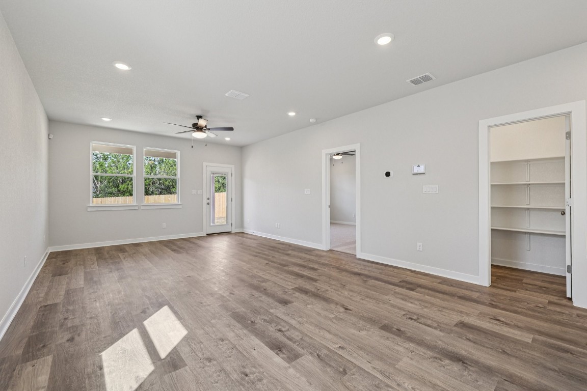 1216 Lavender Way Georgetown, TX 78628 - Photo 10 of 40 a view of an empty room with a window and wooden floor