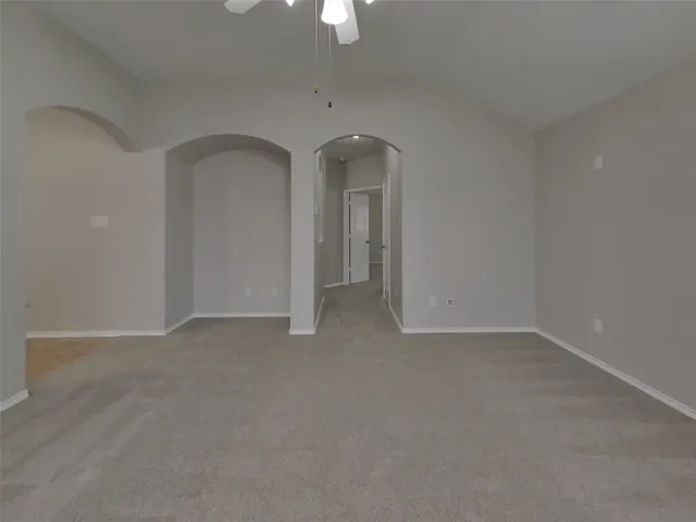 an empty room with closet and mirror