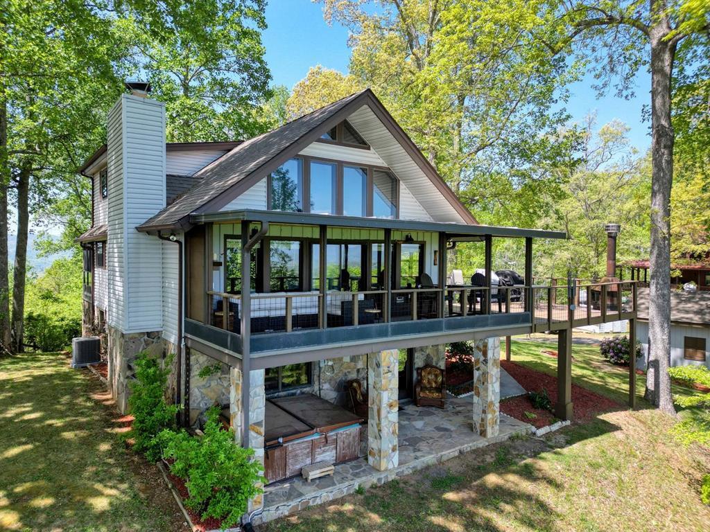 980 Mining Gap Road Young Harris, GA 30582 - Photo 1 of 70 a view of a house with wooden deck and furniture