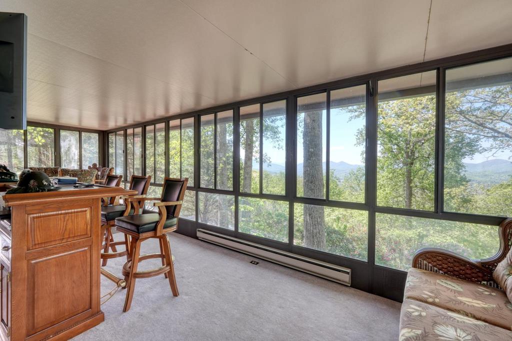 980 Mining Gap Road Young Harris, GA 30582 - Photo 25 of 70 a view of a dining room with furniture a chandelier and large windows