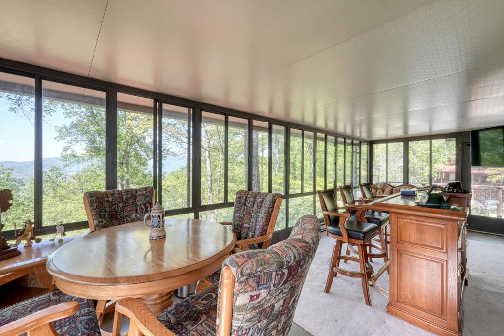 980 Mining Gap Road Young Harris, GA 30582 - Photo 26 of 70 a dining room with furniture large windows and wooden floor