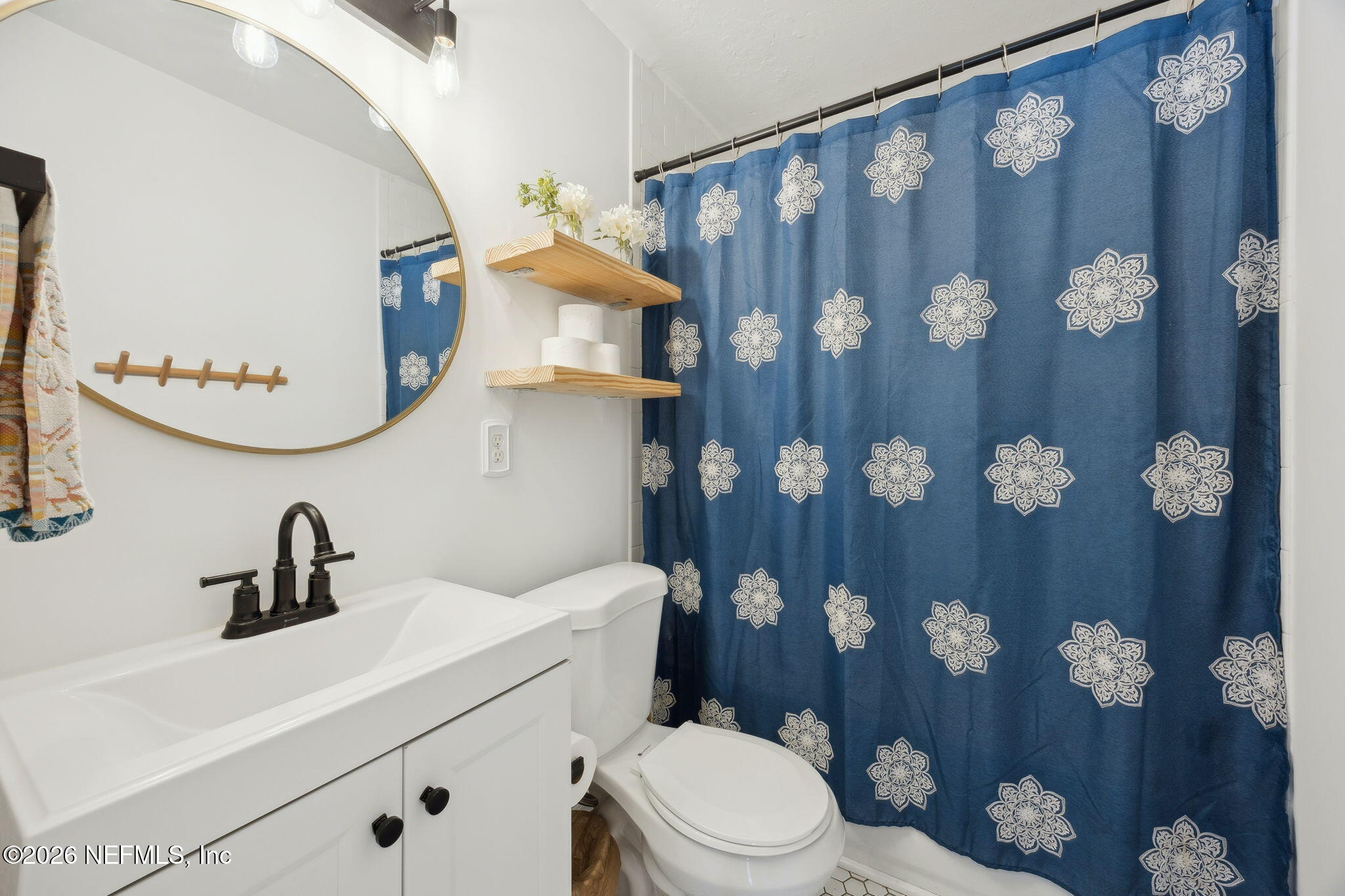 1171 Scotten Road Jacksonville, FL 32205 - Photo 22 of 30 a bathroom with a toilet a sink and mirror