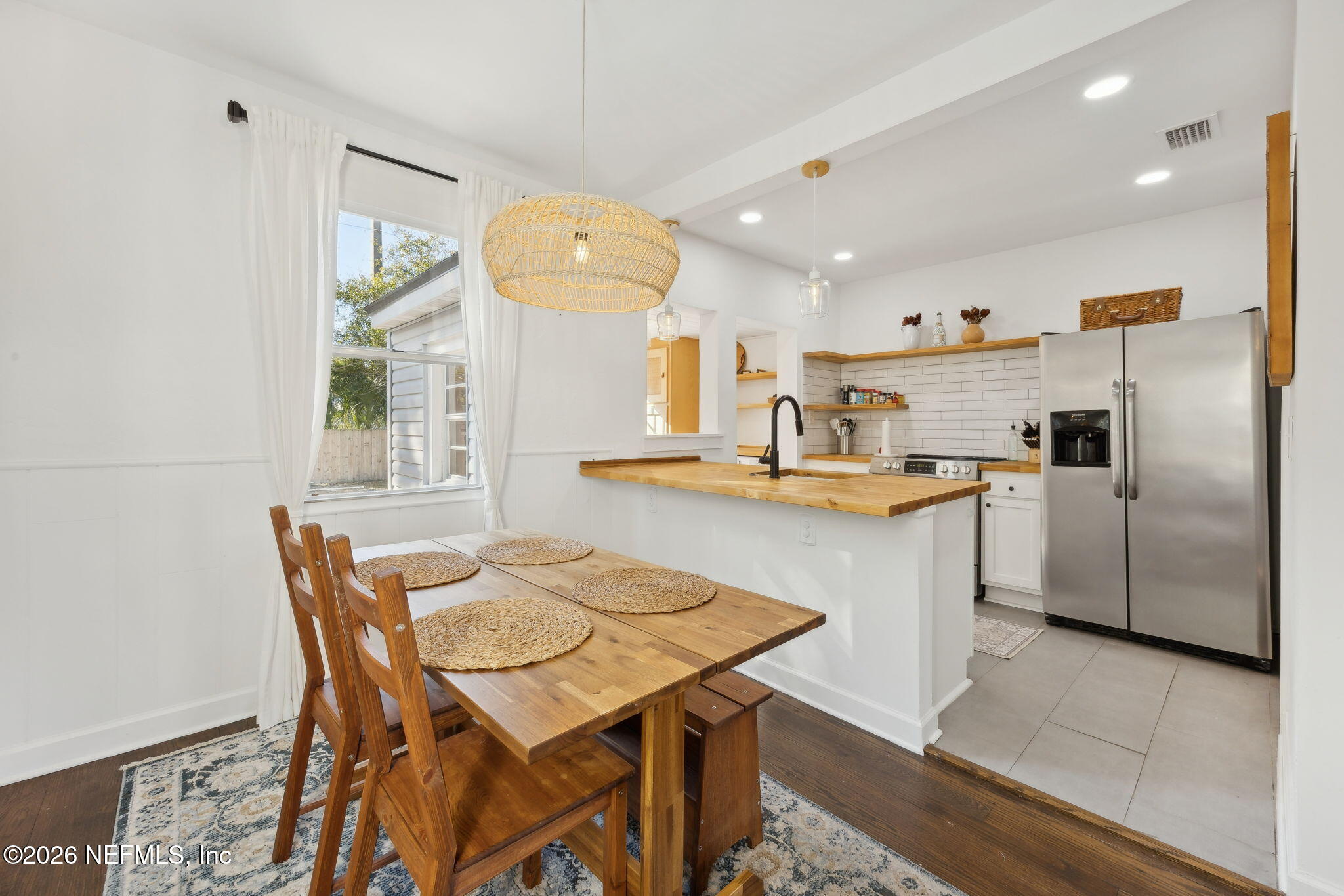 1171 Scotten Road Jacksonville, FL 32205 - Photo 9 of 30 a kitchen with stainless steel appliances kitchen island granite countertop a table chairs and a refrigerator