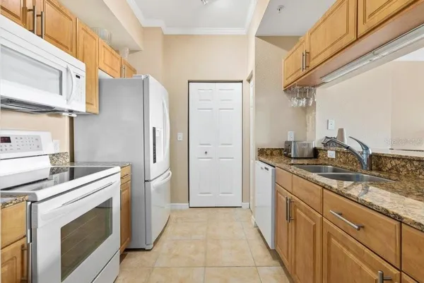 a kitchen with stainless steel appliances granite countertop a refrigerator and a stove